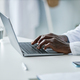 Closeup black doctor using laptop in office - PhotoDune Item for Sale