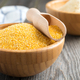 Raw corn grits polenta in a bamboo bowl on the old wooden background. Selective focus - PhotoDune Item for Sale