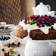 Cake with fresh berries and cream on old wooden background. Selective focus. - PhotoDune Item for Sale