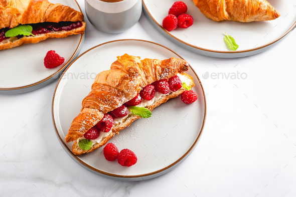 Croissant with fresh raspberries - Stock Photo - Images