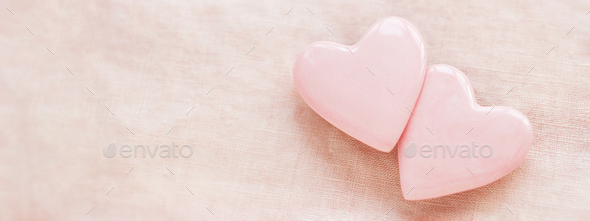 Two pastel pink hearts on pink linen background. - Stock Photo - Images