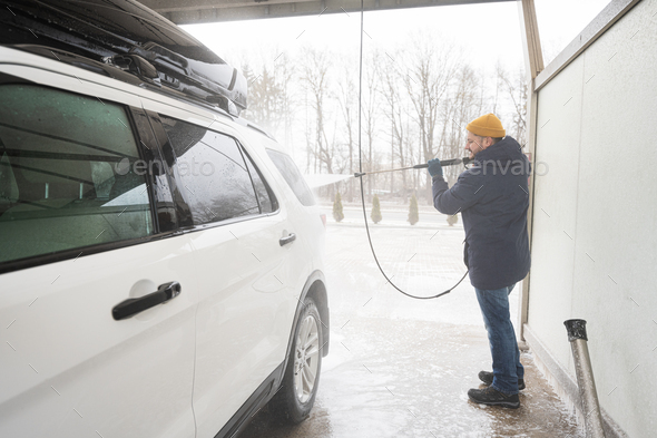 Man washing high pressure water american SUV car  - Stock Photo - Images