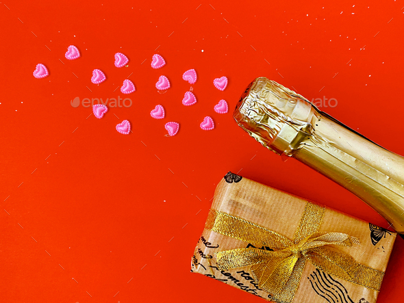 Champagne bottle with confetti and wrapped gift. Flat lay - top view. Valentines day concept. - Stock Photo - Images