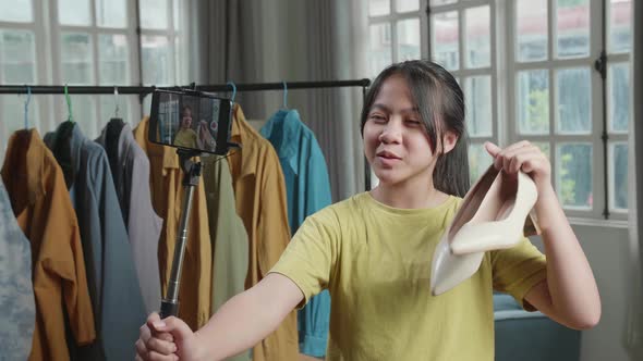 Young Girl Online Seller Recommending Kitten Heels And Recording Video By Mobile Phone alt