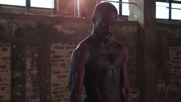 Sport man doing arm exercise with weight at gym portrait alt