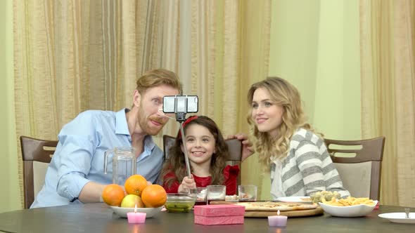 Family Taking Selfie During Dinner alt