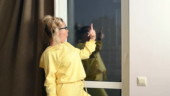 Young Blonde Woman at Home Grimacing and Fooling alt