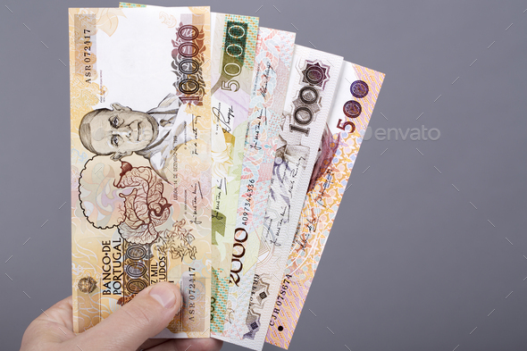 Portuguese money in the hand on a gray background - Stock Photo - Images