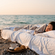 Sleeping woman in bed over sea background - PhotoDune Item for Sale
