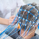 Patient in hospital gown sits with sensors on his head - PhotoDune Item for Sale