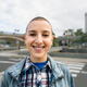 Shaved head girl smiling in front camera - PhotoDune Item for Sale