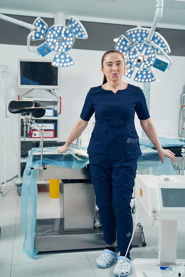 Female surgical center worker standing in operation room