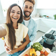 Young happy couple preparing healthy meal in kitchen at home  - PhotoDune Item for Sale