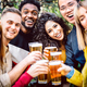 Front view of friends drinking and toasting beer at brewery bar restaurant patio - PhotoDune Item for Sale