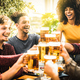 Multiracial friends drinking and toasting beer pint at brewery bar restaurant - PhotoDune Item for Sale
