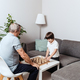 Toddler boy plays chess with grandfather - PhotoDune Item for Sale