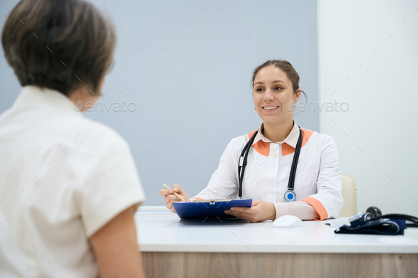 Therapist fixes the complaints of an elderly patient - Stock Photo - Images
