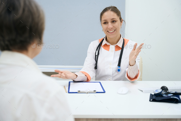 Pleasant doctor leads a reception in a medical clinic - Stock Photo - Images