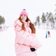 Young red haired woman in pink sportswear on winter snowy background - PhotoDune Item for Sale