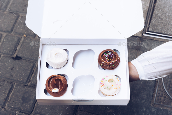 Assorted Gourmet Tasty Cupcakes on a Carboard Box - Stock Photo - Images