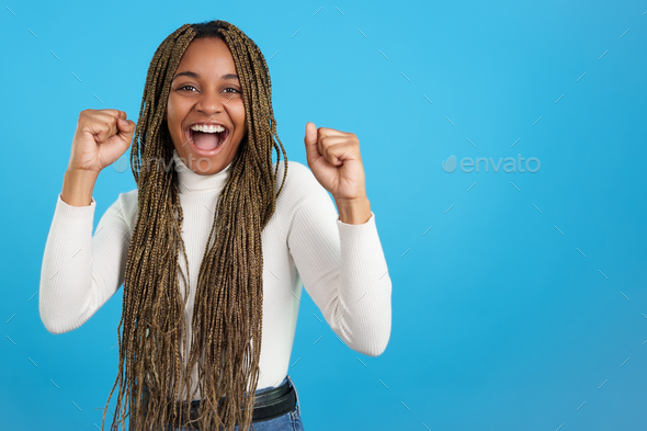African woman celebrating with fists in the air
