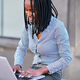 African businesswoman using a laptop in the street - PhotoDune Item for Sale