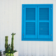 White facade with cactus and blue door on magic Procida Island. - PhotoDune Item for Sale