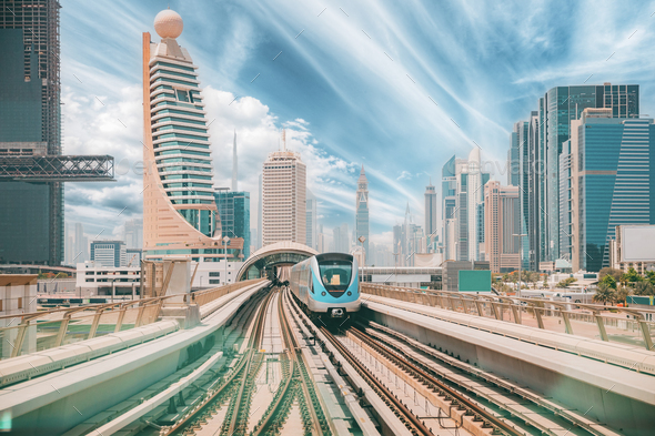 Monorail Subway train rides among glass skyscrapers in Dubai. Traffic on street in Dubai. Cityscape - Stock Photo - Images