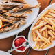 french fries and grilled fishes. fish and chips. Dish with Mullet Fish With orange. Fried fry small - PhotoDune Item for Sale