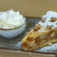 A piece of apple pie on white plate served with whipping cream on the side - PhotoDune Item for Sale