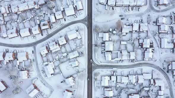 Aerial view of snow covered houses and roads in a residential area of the cit