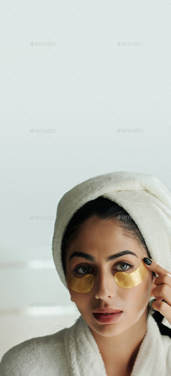 Woman Applying Undereye Patches - Stock Photo - Images