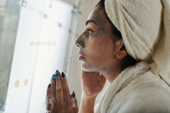 Woman Washing off Brightening Mask - Stock Photo - Images
