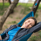 Smiling woman resting in a hammock - PhotoDune Item for Sale