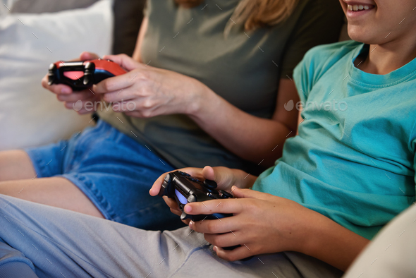Boy and woman playing video game at home - Stock Photo - Images