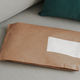 Craft paper soft pack on gray scandinavian sofa - PhotoDune Item for Sale