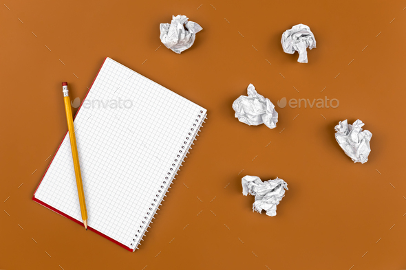 Empty notebook and crumpled paper balls, flat lay. - Stock Photo - Images