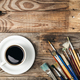 Paint brushes and a cup of coffee on a wooden background, flat lay. - PhotoDune Item for Sale