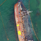 Aerial top view of broken rusty oil tanker ship in the shallow water. - PhotoDune Item for Sale