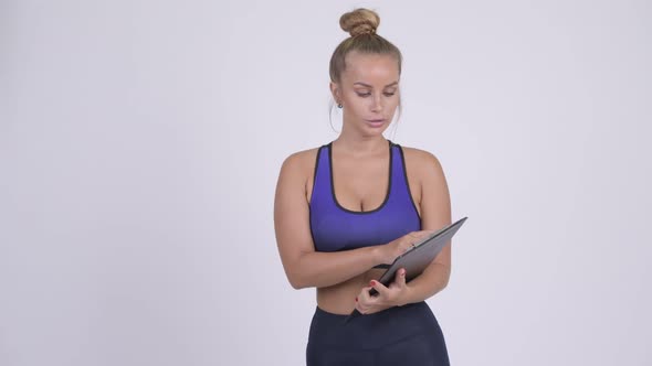 Young Blonde Woman As Gym Instructor Talking and Holding Clipboard alt