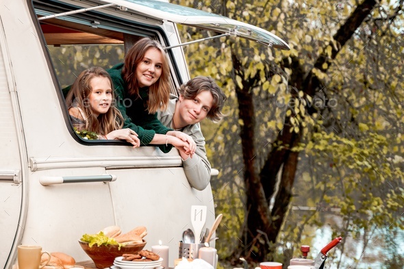 Children,family,brother sister traveling in camper,house on wheels. Trailer motor home.Looking in  - Stock Photo - Images