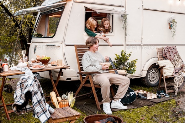 Children,family,brother sister traveling in camper,house on wheels. Trailer motor home.Looking in  - Stock Photo - Images