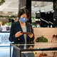 woman wearing mask looking at  women wallet - PhotoDune Item for Sale