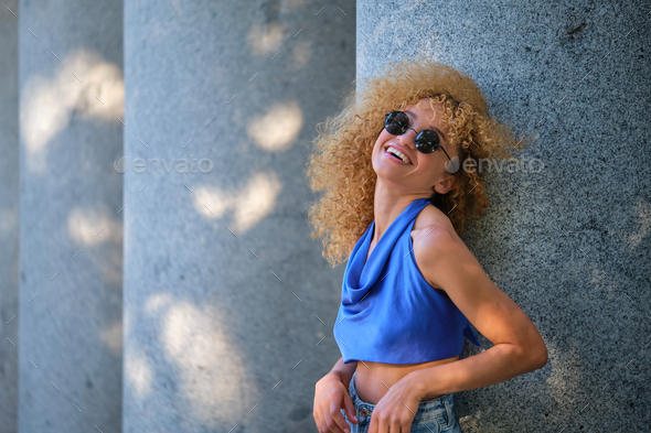 Young Brazilian woman with sunglasses laughing. - Stock Photo - Images