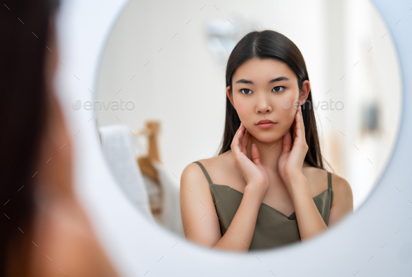 woman looking at mirror - Stock Photo - Images