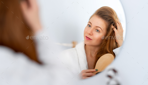woman brushing her red hair - Stock Photo - Images
