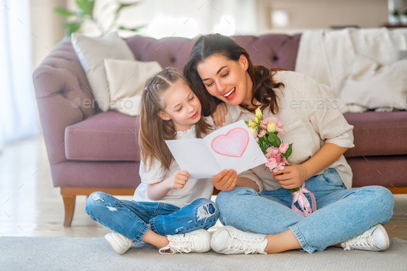 Daughter giving mother bouquet of flowers. - Stock Photo - Images