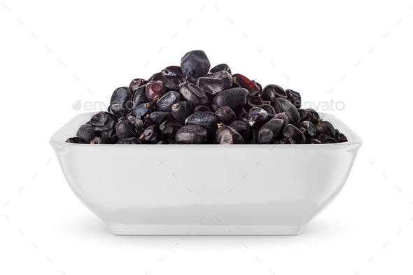 Black dried barberry in white bowl isolated on white. Front view. - Stock Photo - Images