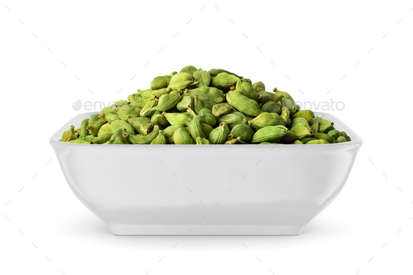 Cardamom pods in white bowl isolated on white. Side view. - Stock Photo - Images