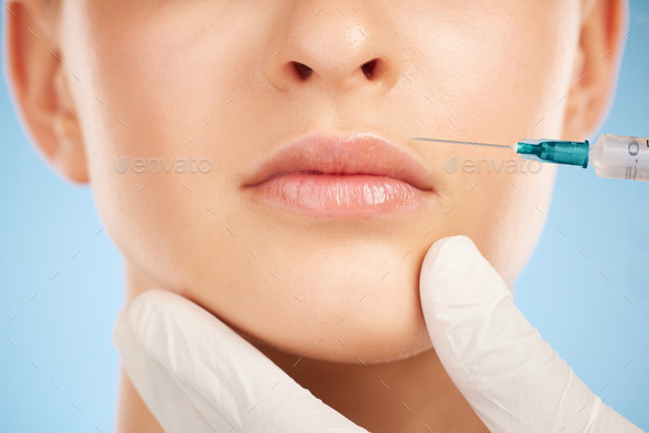 Botox, facial and lip filler by woman with cosmetic injection isolated against a studio blue backgr